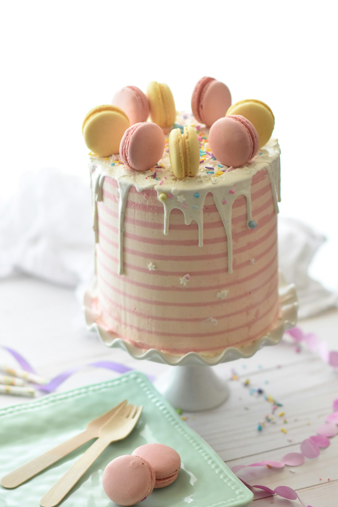 A pastel celebration cake topped with macarons